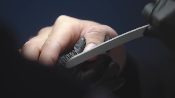 Manicurist Doing Man's Nails Emery Board  Sawing Free Edge Nail