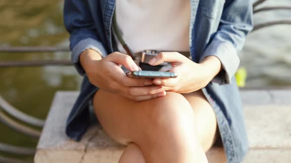 Close up of Asian woman using smartphone devices sharing social media.