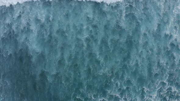 Slowmotion Top Down Aerial View of the Ocean Giant Waves Foaming and Splashing