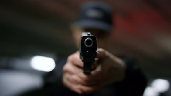 Policewoman Holding Gun in Hands