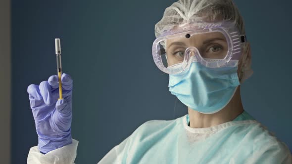 Portrait of a Young Nurse with a Syringe Ready to Vaccinate a Patient Against Covid 19