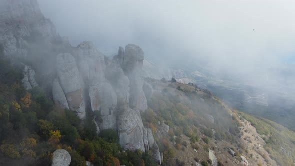 Mountains with Rocky Sculptures That are Getting Covered By Clouds