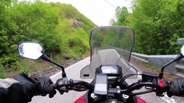 Motorcyclist on Motorbike Rides on a Beautiful Landscape Mountain Road in Italy