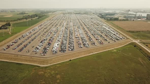 Many new and occasion Cars on a huge parking lot waiting for shipment, Aerial