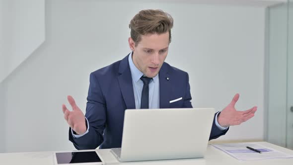 Shocked Young Businessman Reacting To Failure on Laptop