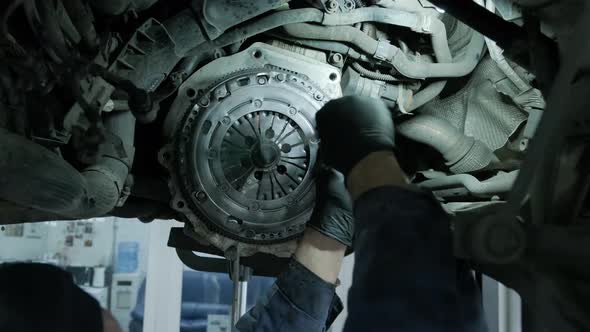 Change and repair clutch, drive axle. working underneath a lifted car