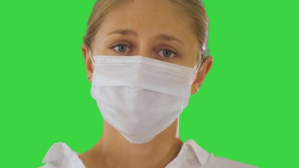 Business Woman in a Protective Medical Mask on a Green Screen, Chroma Key