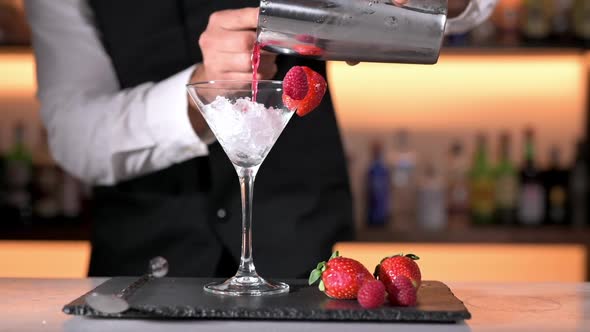 Expert Barman is Making Cocktail at Night Club