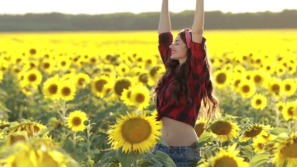 Joyful Woman Spinning Around in Sunflower Field