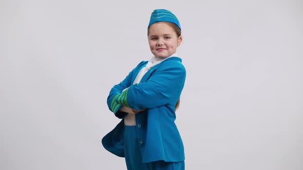 Side View Confident Proud Caucasian Girl in Stewardess Uniform Crossing Hands Looking at Camera