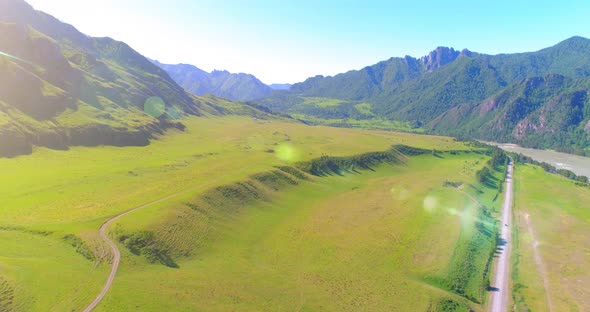 Aerial Rural Mountain Road and Meadow at Sunny Summer Morning