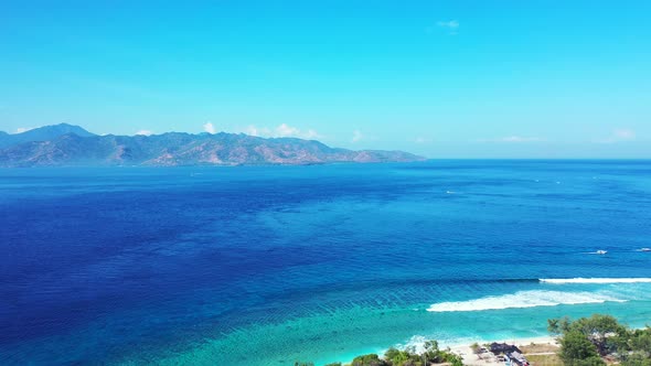 Luxury flying abstract shot of a paradise sunny white sand beach and aqua blue water background in 4