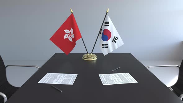 Flags of Hong Kong and South Korea on the Table