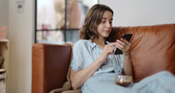 Woman with a Smart Phone at Cozy Home