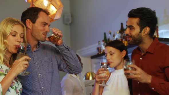 Two couples having cocktails together in restaurant