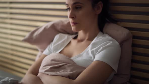 Tracking video of depressed woman in bed. Shot with RED helium camera in 8K.