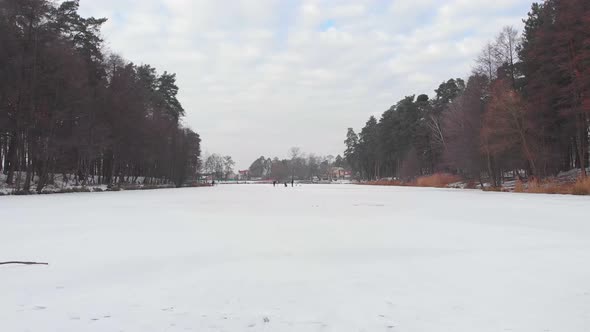 People Walk On Frozen Lake