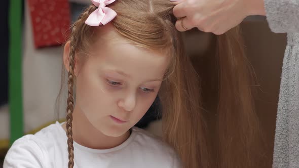 Mother Braids Daughter Closeup