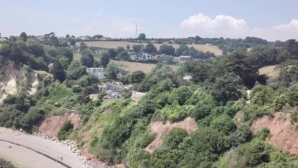 Flying close to the cliffs and rock formations on the beach of Seaton in east Devon, England. The wh