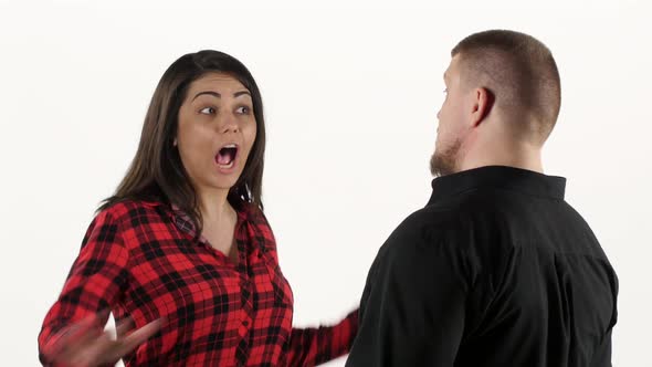 Furious Woman Swears with Her Man and Waving Her Arms. White