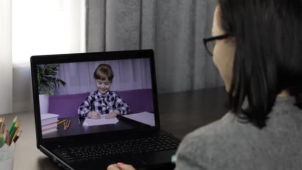 Woman Teacher Making Video Call on Laptop with Little Pupil. Distance Education