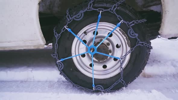 Snow Chains Mounted on a Car