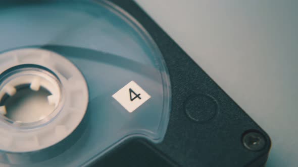 Retro Compact Cassette in Black Case on White Background