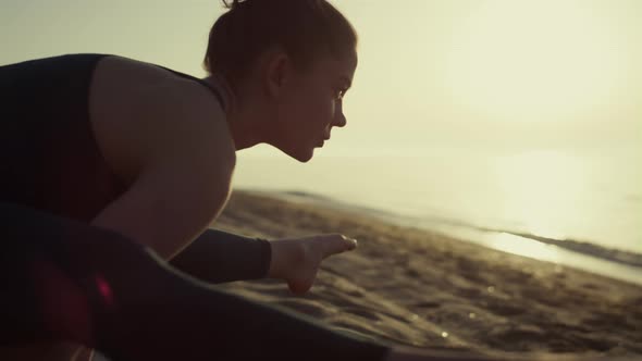 Sportswoman Making Gymnastics Exercises on Beach