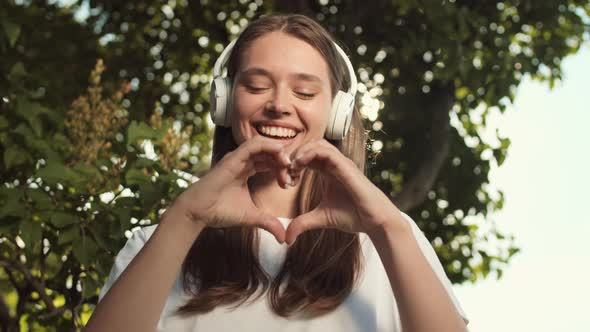 Woman Showing Heart Sign with Hands