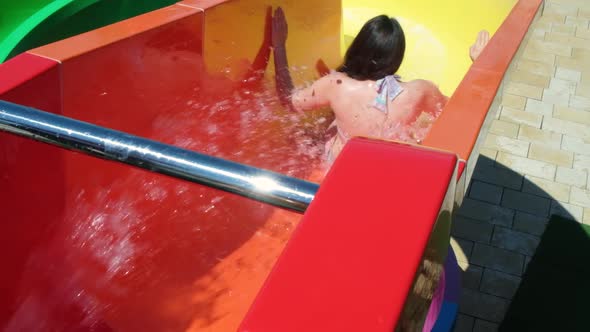 Woman Pulls Down a Water Slide in an Aqua Park Slow Motion