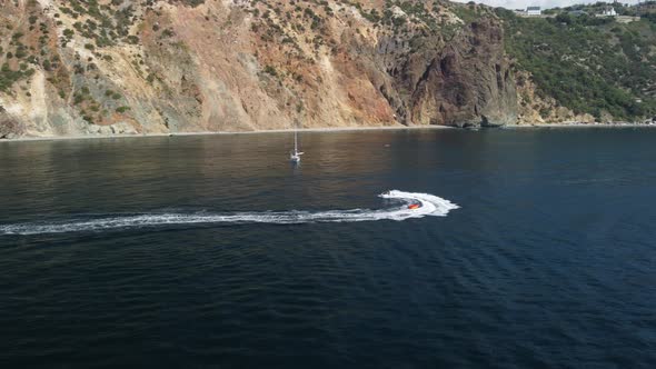 Happy People Swim on Air Mattress Behind a High Speed Water Bike