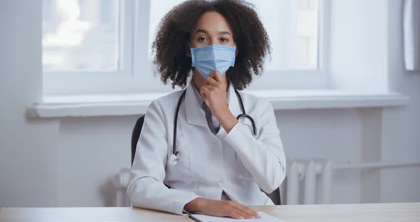 Happy Smiling Female Doctor Taking Off Protective Medical Face Mask After Coronavirus Pandemic