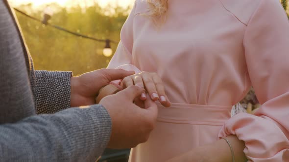 Groom Puts the Wedding Ring on Bride.