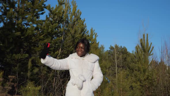 Black Woman Makes Selfie in Winter Forest Under Clear Sky