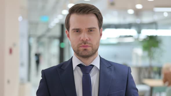 Portrait of Upset Businessman Feeing Sad at Camera 