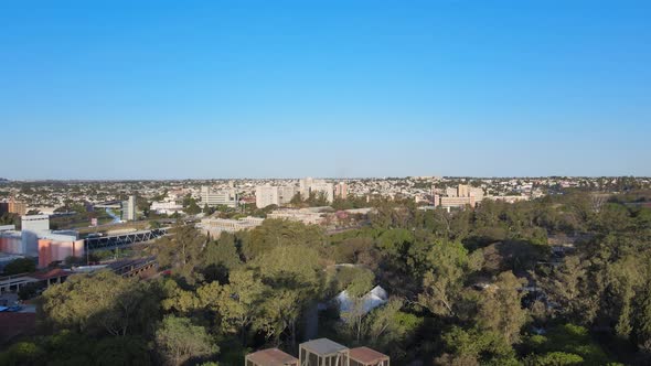 Drone reverse flying overlooking distance downtown cityscape, reveals iconic landmark rusty old ferr