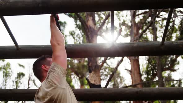 Military soldier climbing monkey bars 4k