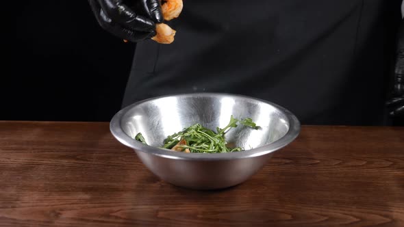 Chef Cooking Salad with Shrimps in Stainless Bowl in Slow Motion