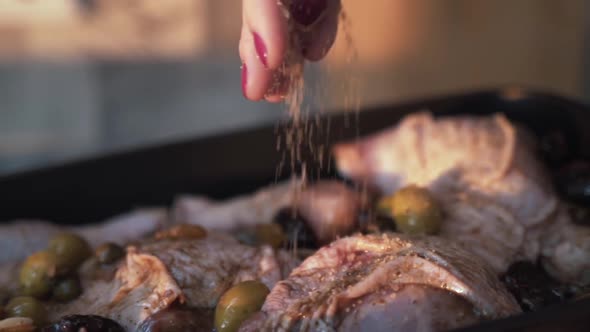 Adding spices mix into raw chicken