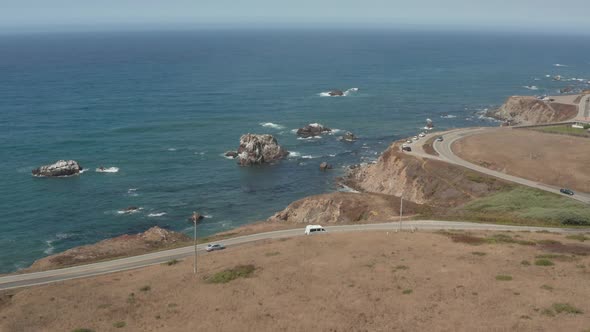Aerial view of cars driving down Highway 1 by the ocean Bodega Bay n Northern California