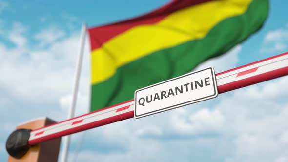 Opening Barrier with QUARANTINE Sign at the Bolivian Flag