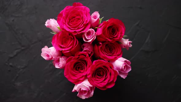 Pink Roses Bouquet Packed in Red Box and Placed on Black Stone Background