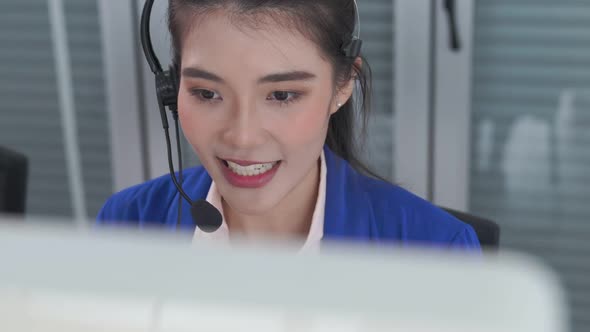 Businesswoman Wearing Headset Working Actively in Office