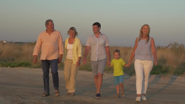 Big Family Walking in the Countryside at Sunset