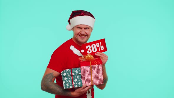 Man in Christmas Tshirt Showing Gift Boxes and 30 Percent Discount Inscriptions Banner Text Note