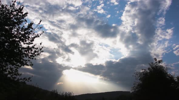 Time lapse of sun rays shining through the clouds