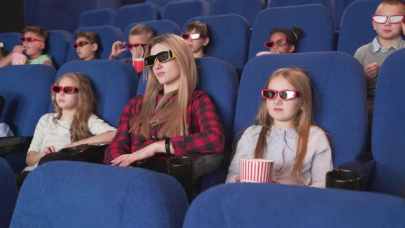 Modern Cinema with Children Watching Cartoon in 3d Glasses