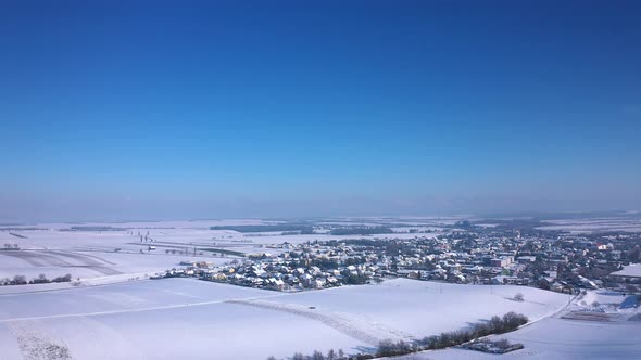 Idyllic Town Of Zistersdorf On Winterly Landscape Against Blue Sky In Lower Austria. Aerial Wide Sho