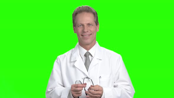 Mature Doctor Using Stethoscope.