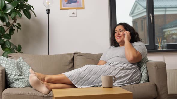 Happy Young Woman Calling on Smartphone at Home